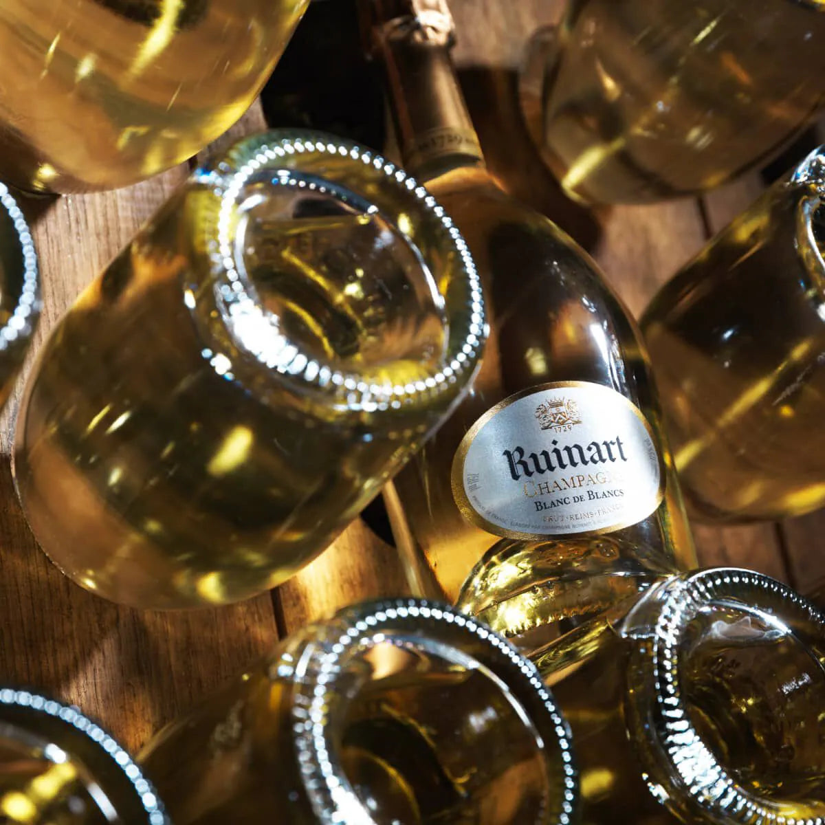 Ruinart Blanc de Blancs champagneflasker arrangeret i pupitre-stil, set ovenfra